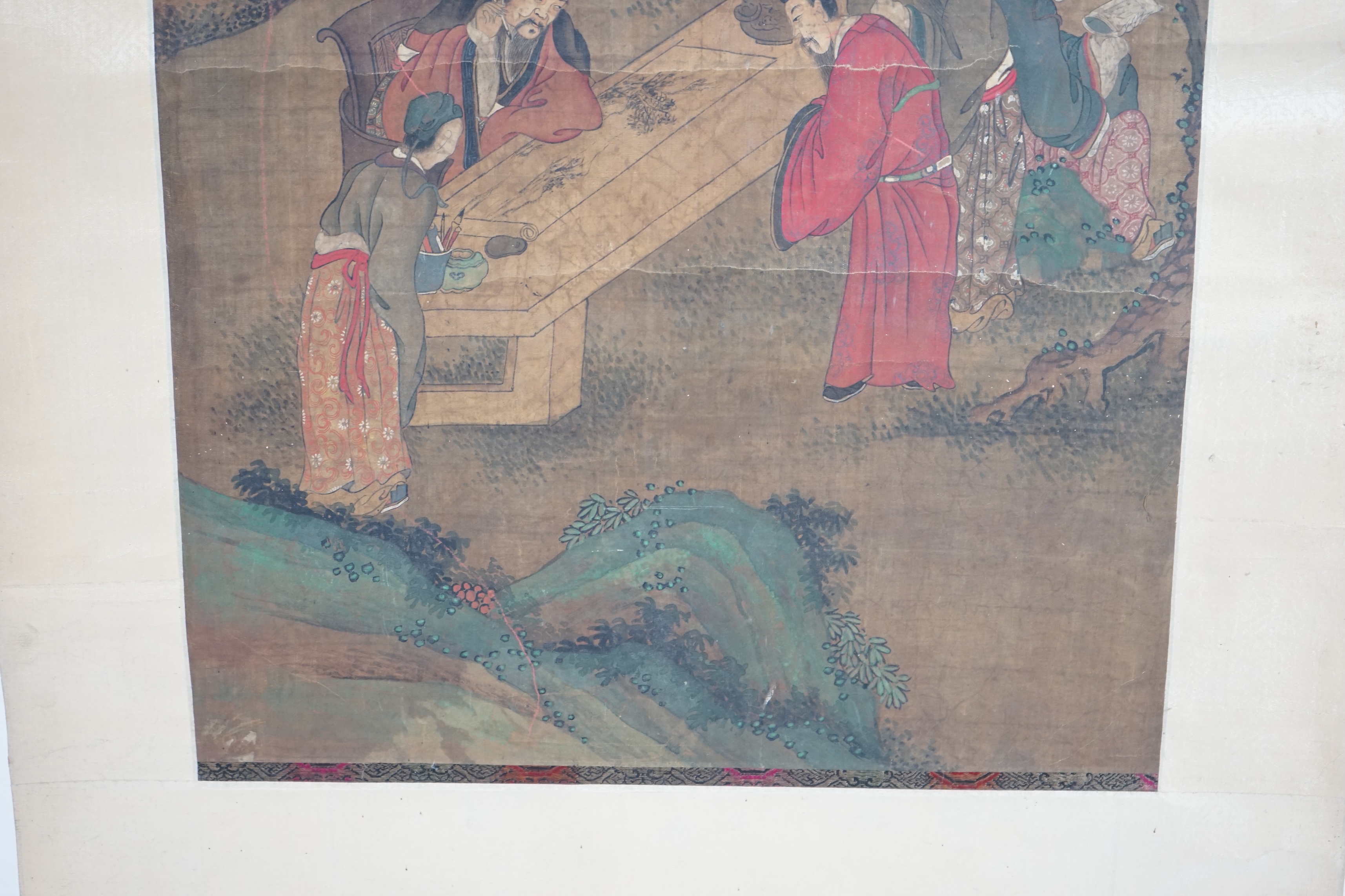 Chinese School, 19th century, scroll painting, ink and colour on silk, scholars in a garden examining a painting